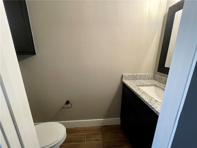 bathroom featuring hardwood / wood-style flooring, vanity, and toilet