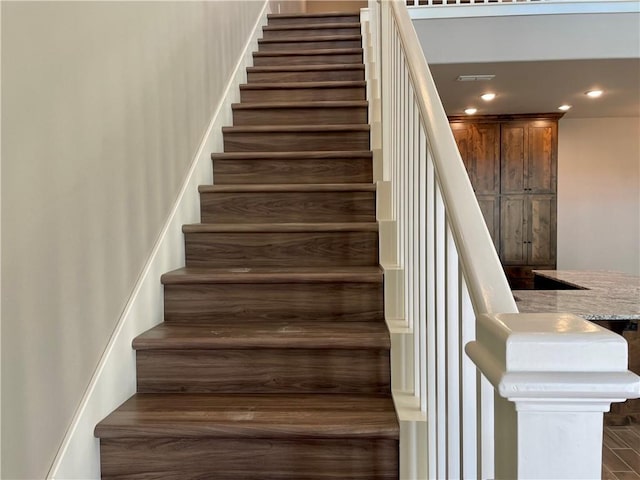 staircase with hardwood / wood-style flooring