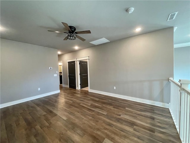 spare room featuring ceiling fan, crown molding, and dark hardwood / wood-style floors