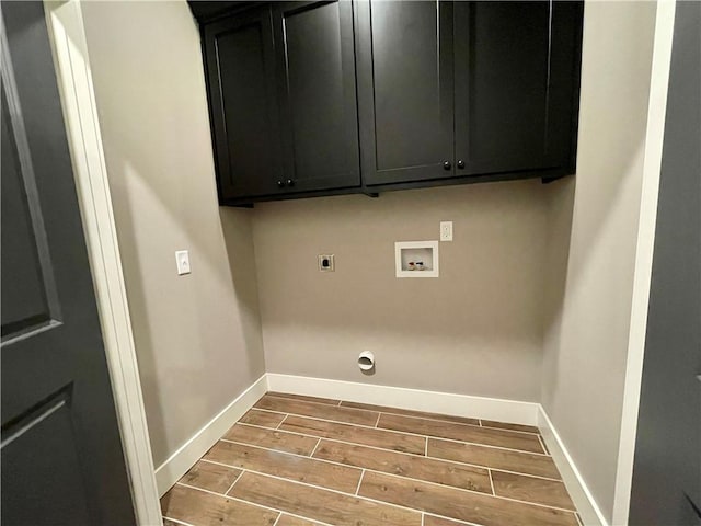 clothes washing area featuring electric dryer hookup, cabinets, and hookup for a washing machine