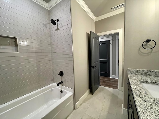 bathroom featuring vanity, tiled shower / bath, and ornamental molding