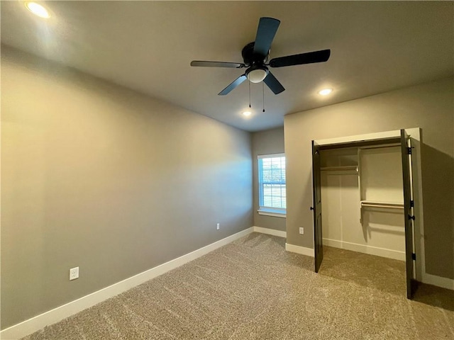 unfurnished bedroom featuring ceiling fan, a closet, and carpet