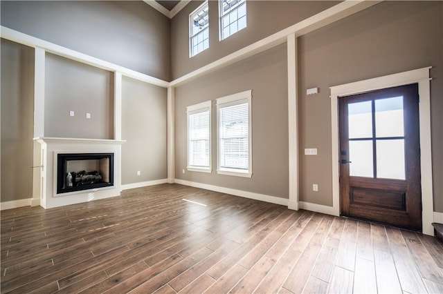 entryway with a healthy amount of sunlight, a high ceiling, and hardwood / wood-style flooring