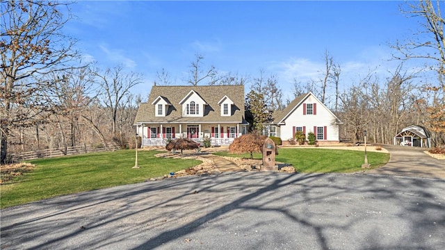 cape cod house with covered porch and a front yard