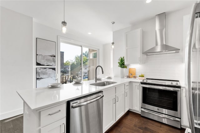 kitchen with white cabinets, sink, wall chimney range hood, and stainless steel appliances