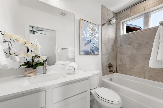 full bathroom with vanity, toilet, and tiled shower / bath combo