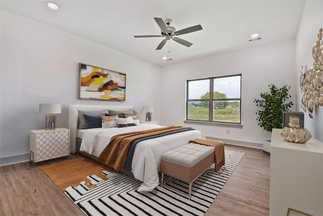 bedroom with wood-type flooring and ceiling fan