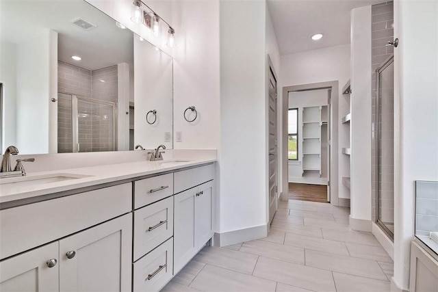 bathroom featuring vanity and a shower with shower door