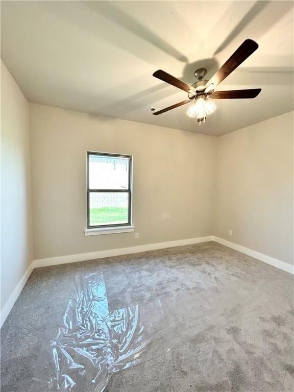 carpeted empty room featuring ceiling fan