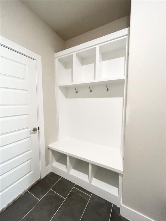 mudroom featuring dark tile patterned flooring