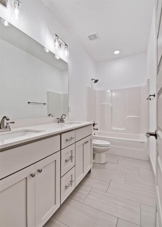 full bathroom with vanity, toilet, and shower / washtub combination