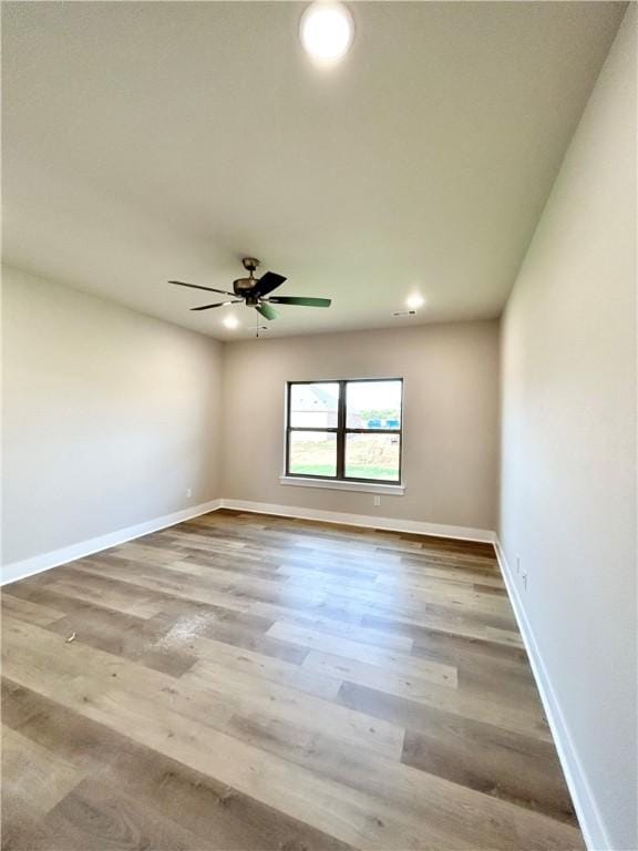 unfurnished room featuring ceiling fan and wood-type flooring