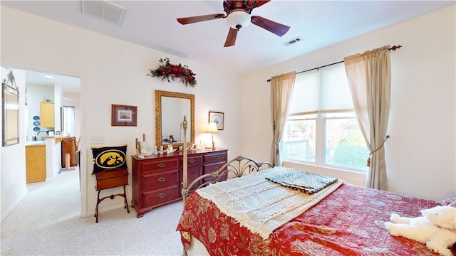 bedroom with light colored carpet and ceiling fan