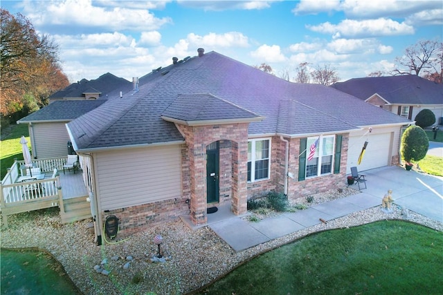 view of front of house featuring a front yard, a garage, and a wooden deck