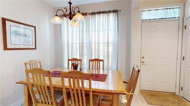 dining area featuring plenty of natural light and an inviting chandelier