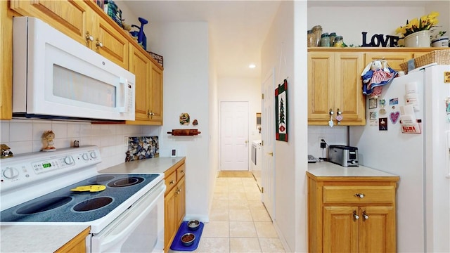 kitchen featuring decorative backsplash, light tile patterned floors, and white appliances