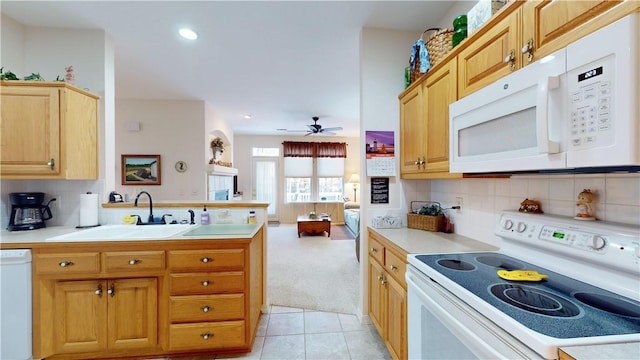 kitchen with white appliances, sink, ceiling fan, tasteful backsplash, and light colored carpet