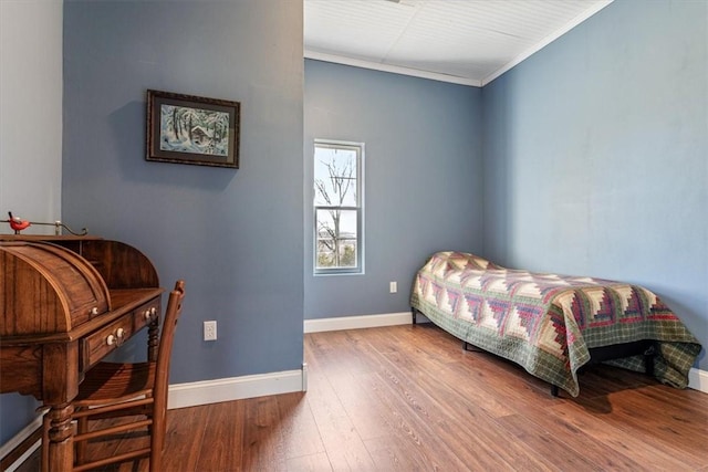 bedroom featuring wood-type flooring and crown molding