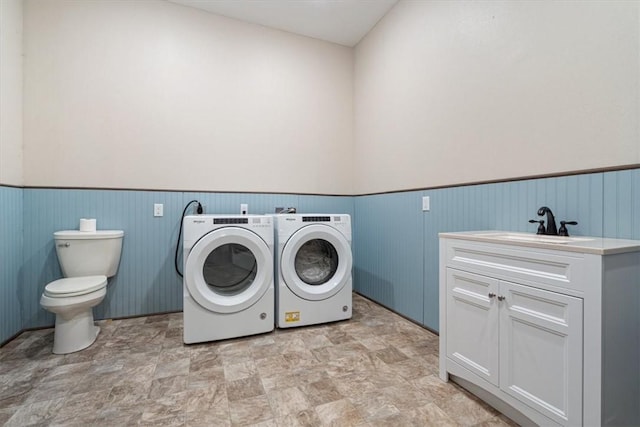 clothes washing area with washer and dryer and sink