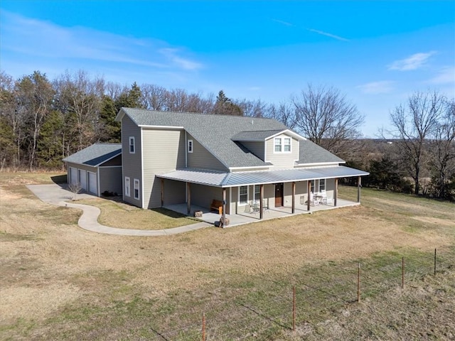 view of front facade featuring a patio area, a garage, and a front lawn