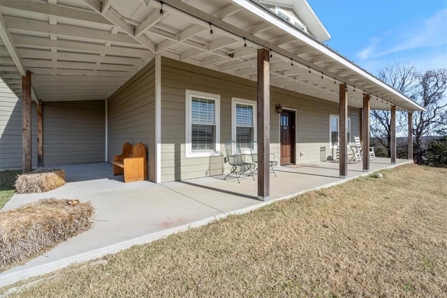 entrance to property with a lawn