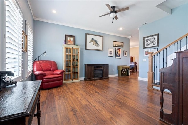 sitting room with ceiling fan, dark hardwood / wood-style floors, and ornamental molding