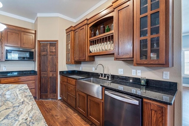 kitchen with dishwasher, sink, dark hardwood / wood-style floors, dark stone countertops, and crown molding