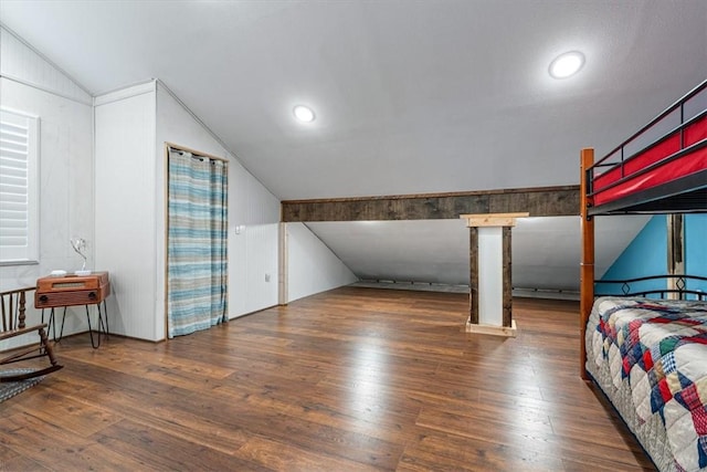 bedroom featuring dark hardwood / wood-style flooring and lofted ceiling