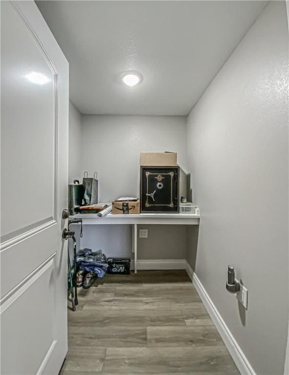 laundry area with light hardwood / wood-style floors