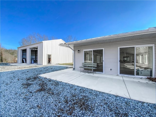 rear view of property with an outdoor structure