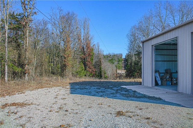 view of yard featuring a garage and an outdoor structure