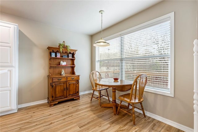 dining space with light wood-type flooring and plenty of natural light