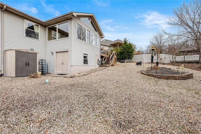 view of home's exterior with a shed and a deck