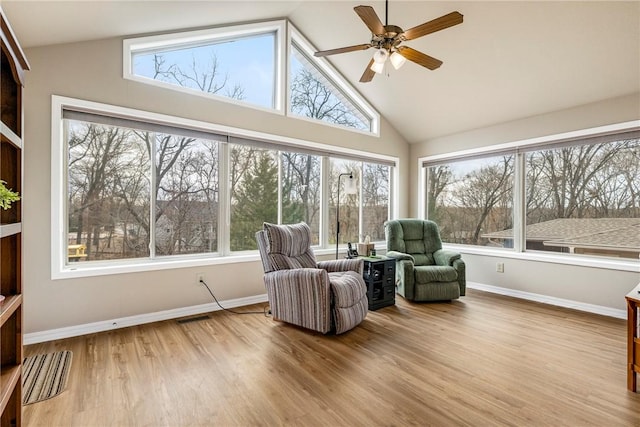 sunroom featuring vaulted ceiling, plenty of natural light, and ceiling fan