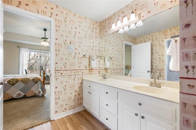 bathroom featuring ceiling fan, vanity, and hardwood / wood-style flooring