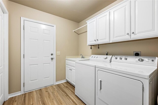 3 Barrhead Ln, Bella Vista, AR 72715 - laundry area featuring baseboards, light wood finished floors, a sink, washing machine and clothes dryer, and cabinet space