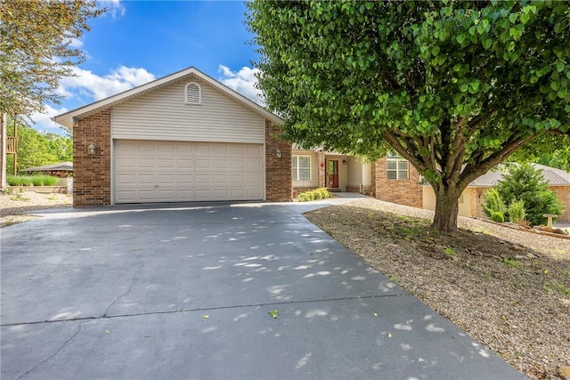 3 Barrhead Ln, Bella Vista, AR 72715 - view of front of property with concrete driveway, brick siding, and a garage