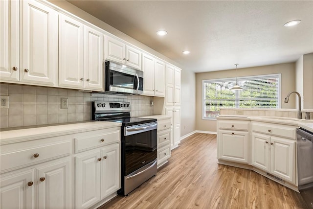 3 Barrhead Ln, Bella Vista, AR 72715 - kitchen featuring a sink, stainless steel appliances, white cabinets, light wood-type flooring, and tasteful backsplash