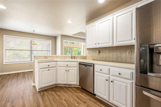 3 Barrhead Ln, Bella Vista, AR 72715 - kitchen with white cabinets, light wood-style floors, stainless steel appliances, and a sink
