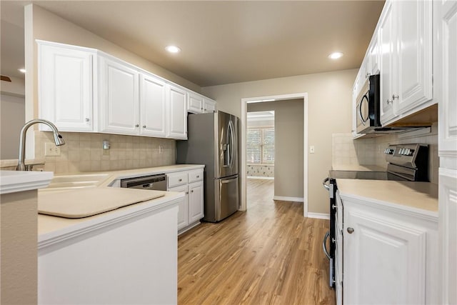 3 Barrhead Ln, Bella Vista, AR 72715 - kitchen featuring a sink, stainless steel appliances, white cabinetry, and light wood-style floors