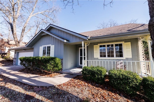 ranch-style home featuring covered porch and a garage