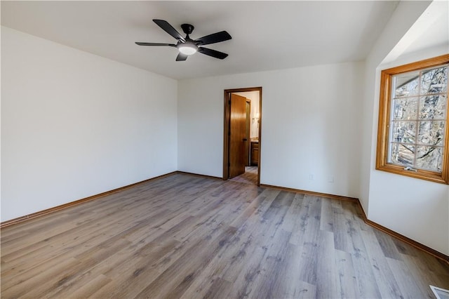 empty room featuring ceiling fan and light wood-type flooring