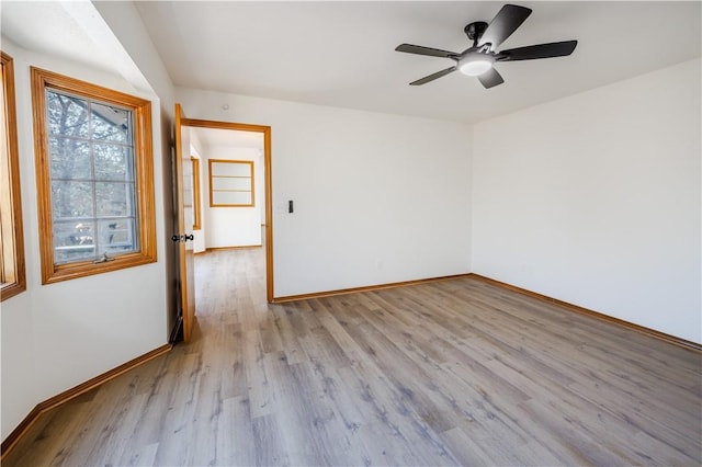 empty room featuring ceiling fan and light hardwood / wood-style flooring