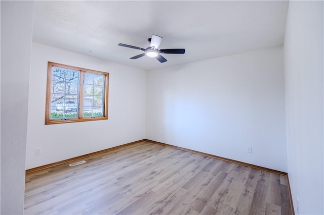 unfurnished room with ceiling fan and light wood-type flooring