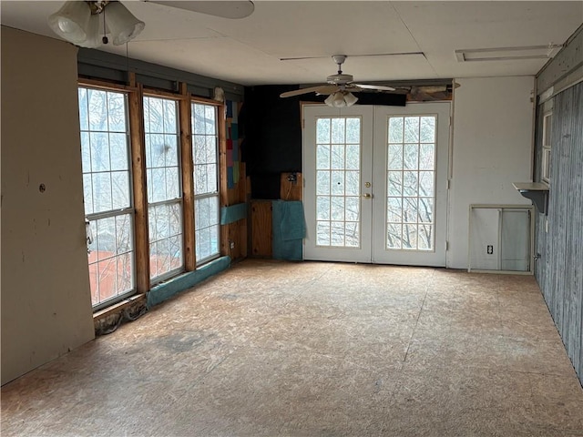 unfurnished dining area featuring french doors, ceiling fan, and a healthy amount of sunlight