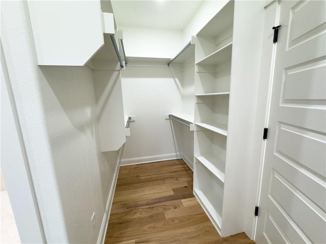 walk in closet featuring light hardwood / wood-style flooring