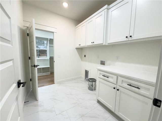 laundry area featuring washer hookup, electric dryer hookup, and cabinets