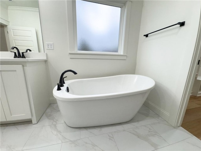 bathroom with a bathing tub and vanity