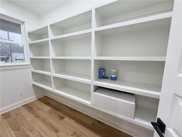 room details featuring baseboards and wood finished floors