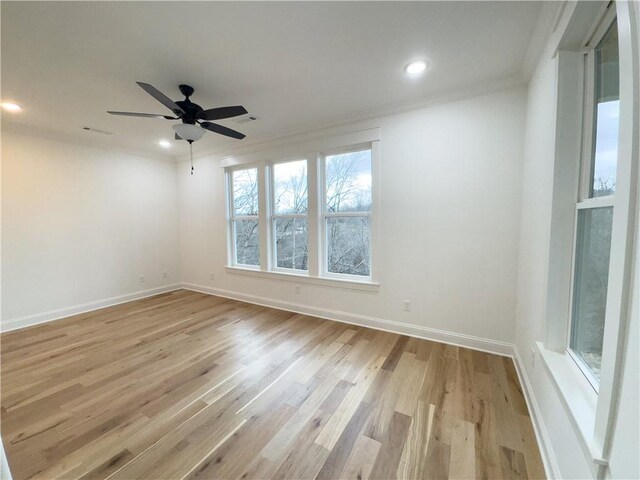 spare room with light hardwood / wood-style floors, ceiling fan, and ornamental molding